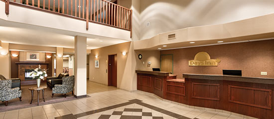 The spacious lobby with a fireplace, chairs and more at Days Inn in Thunder Bay North